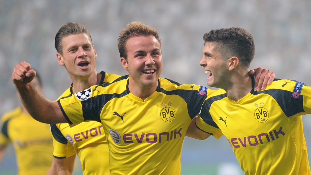 Dortmund's Mario Goetze, center, celebrates with Christian Pulisic, right, after scoring the first goal of his team during the Champions League Group F soccer match between Legia Warsaw and Dortmund at Stadion Wojska Polskiego in Warsaw, Poland, Wednesday, Sept. 14, 2016. (AP Photo/Alik Keplicz)