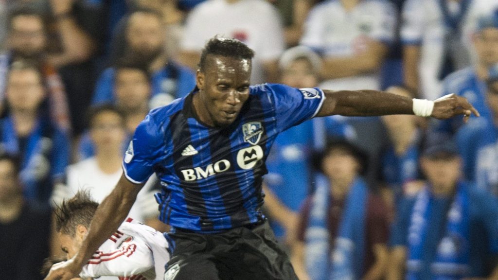 Montreal Impact forward Didier Drogba heads the ball in front of D.C. United midfielder Marcelo Sarvas during the second half of an MLS soccer match Wednesday, Aug. 24, 2016, in Montreal. (Paul Chiasson/The Canadian Press via AP)
