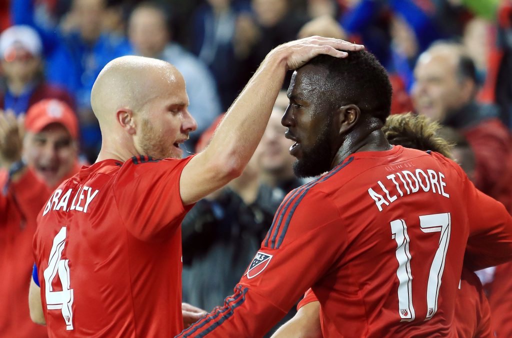 TORONTO, ON - MAY 07: Michael Bradley #4 and Jozy Altidore #17 of Toronto FC celebrate a goal by teammate Tsubasa Endoh #9 during the first half of an MLS soccer game against FC Dallas at BMO Field on May 7, 2016 in Toronto, Ontario, Canada. (Photo by Vaughn Ridley/Getty Images)