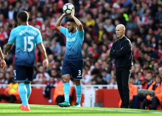 LONDON, ENGLAND - OCTOBER 15: Neil Taylor of Swansea City (C) takes a throw in while Bob Bradley, Manager of Swansea City (R) looks on during the Premier League match between Arsenal and Swansea City at Emirates Stadium on October 15, 2016 in London, England. (Photo by Mike Hewitt/Getty Images)
