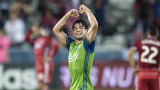 Seattle Sounders midfielder Nicolas Lodeiro (10) exults as FC Dallas midfielder Carlos Gruezo (7) lies on the turf at the end of an MLS soccer western conference semifinal playoff match Sunday, Nov. 6, 2016 in Frisco, Texas. Though Dallas won 2-1, Seattle advanced in the playoffs on aggregate score. (AP Photo/Jeffrey McWhorter)