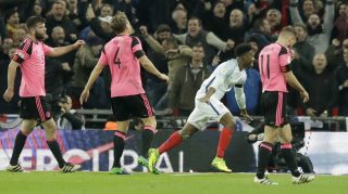 England's Daniel Sturridge, second right, celebrates after scoring his side's first goal as Scotland's Grant Hanley, left, Christophe Berra, second left, and Graham Morrison, right, react during the World Cup group F qualifying soccer match between England and Scotland at the Wembley stadium, London, Friday, Nov. 11, 2016. (AP Photo/Matt Dunham)