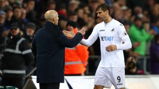 SWANSEA, WALES - DECEMBER 10: Bob Bradley, Manager of Swansea City (L) embraces Fernando Llorente of Swansea City (R) after he is subbed during the Premier League match between Swansea City and Sunderland at the Liberty Stadium on December 10, 2016 in Swansea, Wales. (Photo by Michael Steele/Getty Images)
