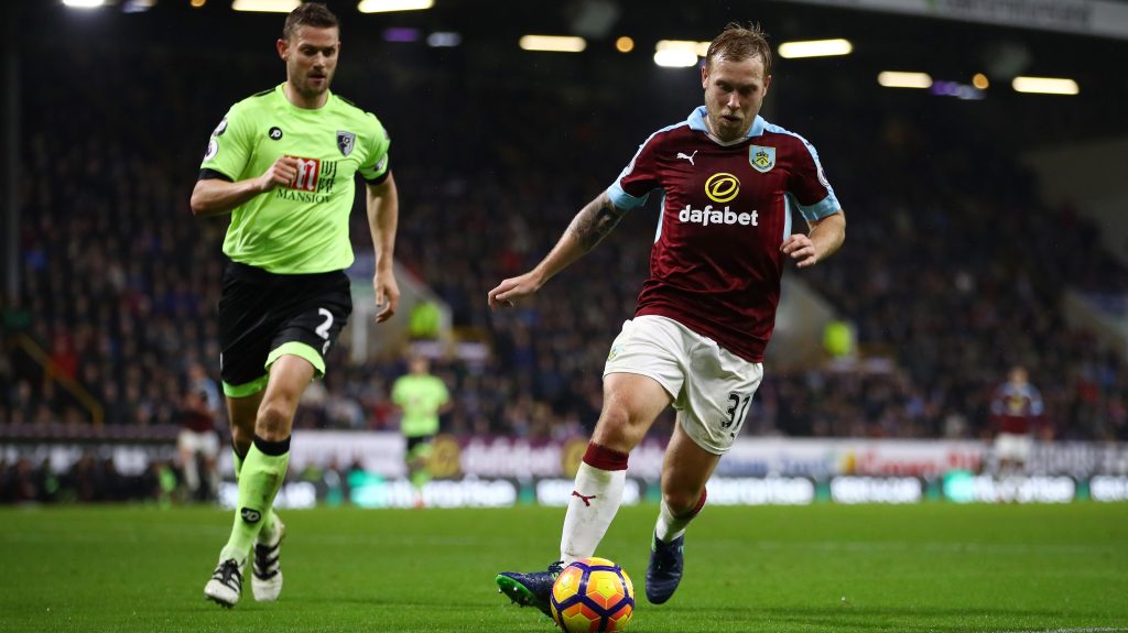 BURNLEY, ENGLAND - DECEMBER 10: Ashley Barnes of Burnley (R) is put under pressure from Simon Francis of AFC Bournemouth (L) during the Premier League match between Burnley and AFC Bournemouth at Turf Moor on December 10, 2016 in Burnley, England. (Photo by Clive Brunskill/Getty Images)