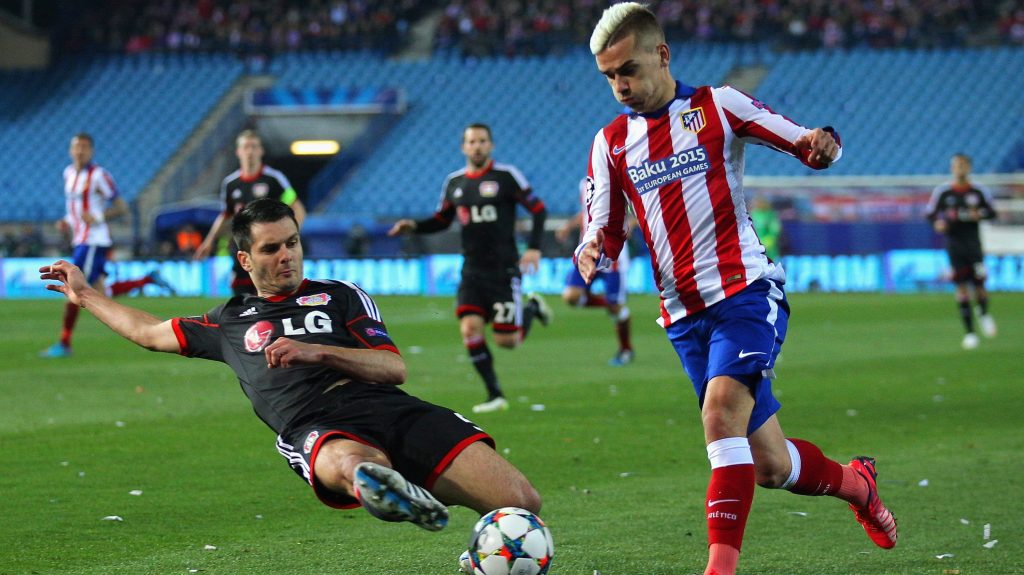 MADRID, SPAIN - MARCH 17: Antoine Griezmann of Atletico Madrid leaps over the challenge from Emir Spahic of Bayer Leverkusen during the UEFA Champions League round of 16 match between Club Atletico de Madrid and Bayer 04 Leverkusen at Vicente Calderon Stadium on March 17, 2015 in Madrid, Spain. (Photo by Gonzalo Arroyo Moreno/Getty Images)