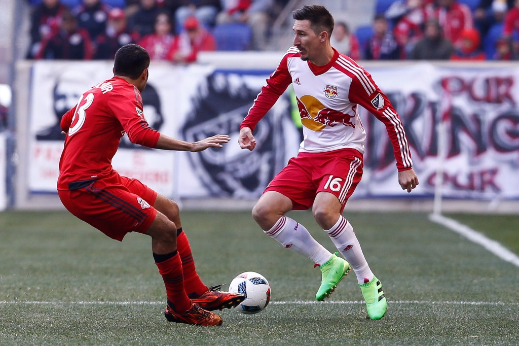 HARRISON, NJ - MARCH 6: Sacha Kljestan #16 of New York Red Bulls dribbles past Steven Beitashour #33 of Toronto FC during their match at Red Bull Arena on March 6, 2016 in Harrison, New Jersey. (Photo by Jeff Zelevansky/Getty Images)