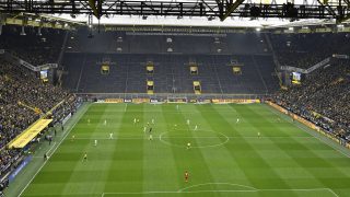 Players challenge for the ball in front of the empty south tribune during the German Bundesliga soccer match between Borussia Dortmund and VfL Wolfsburg in Dortmund, Saturday, Feb. 18, 2017. The German Football Association (DFB) has called for Dortmund's famous south stand to be closed following crowd trouble in the Bundesliga match against RB Leipzig 2 weeks ago. (AP Photo/Martin Meissner)