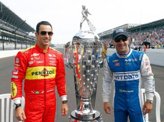 INDIANAPOLIS, IN - MAY 27: Helio Castroneves and Tony Kanaan of Brazil pose on the finish line with the Borg-Warner trophy during Carb Day ahead of the 100th running of the Indianapolis 500 at Indianapolis Motorspeedway on May 27, 2016 in Indianapolis, Indiana. (Photo by Jamie Squire/Getty Images)