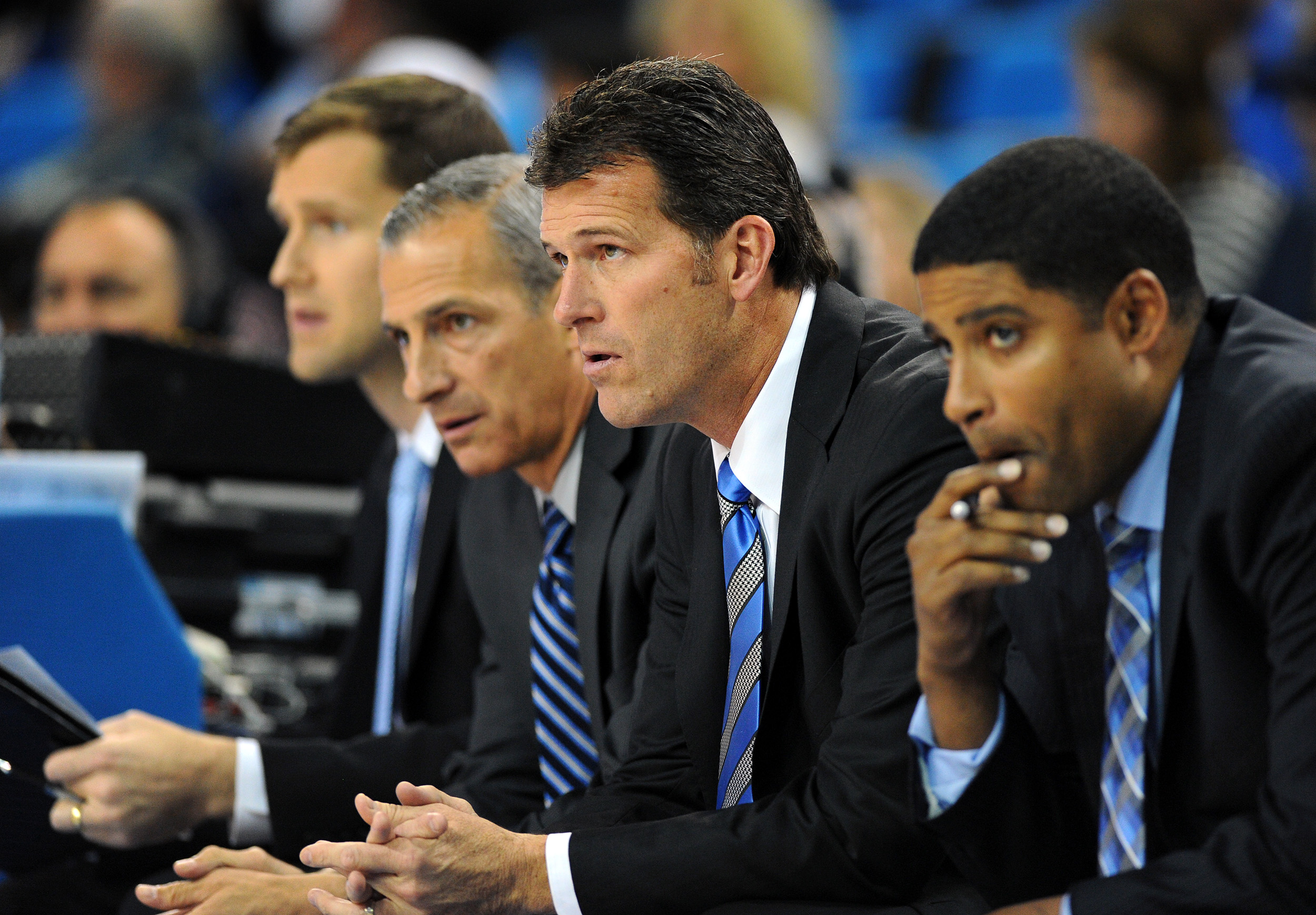 UCLA head coach Steve Alford, second from right, watches action against Cal Poly with his assistant coaches in the first half of an NCAA college basketball game in Los Angeles, Sunday, Nov. 15, 2015. (AP Photo/Michael Baker)