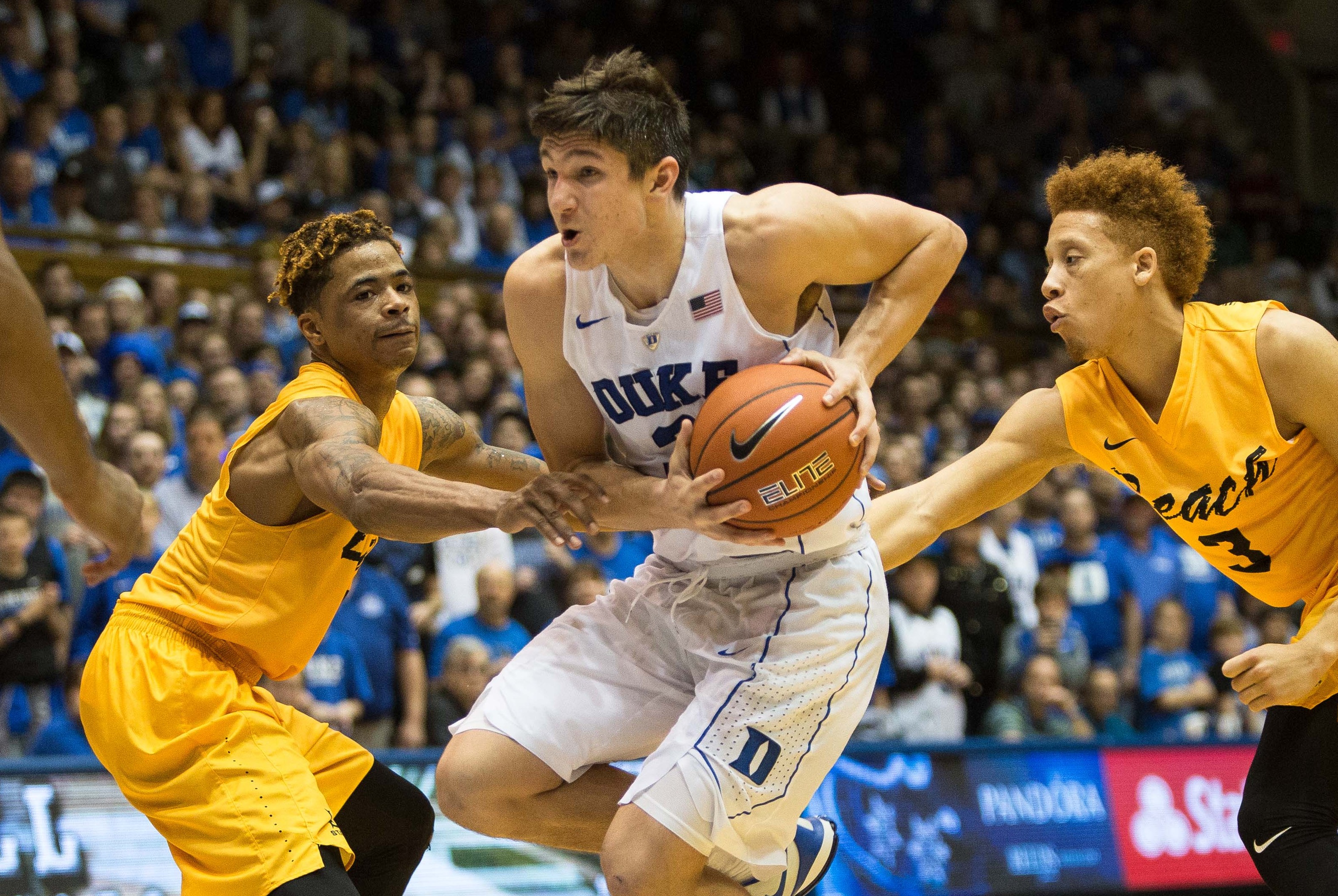 Dukes Grayson Allen, center, handles the ball as Long Beach States Nick Faust, left, and Long Beach States Noah Blackwell (3) defend during the second half of an NCAA college basketball game in Durham, N.C. Wednesday, Dec. 30, 2015. Duke won 103-81. (AP Photo/Ben McKeown)