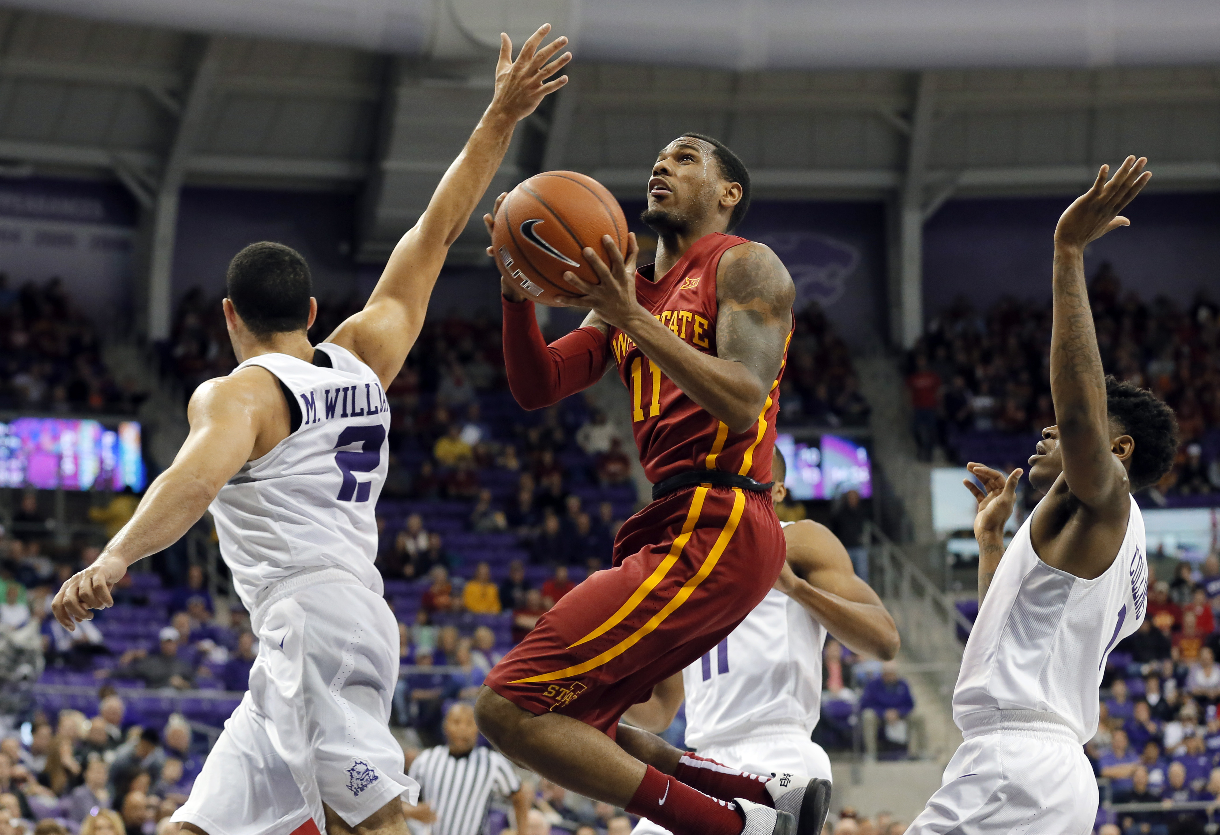TCU guard Michael Williams (2) defends as Iowa State guard Monte Morris (11) leaps to the basket for a shot in the first half of an NCAA college basketball game, Saturday, Jan. 23, 2016, in Fort Worth, Texas. Morris had 18 points and six assists and No. 19 Iowa State followed a win over top-ranked Oklahoma with a 73-60 victory over TCU on Saturday. (AP Photo/Tony Gutierrez)