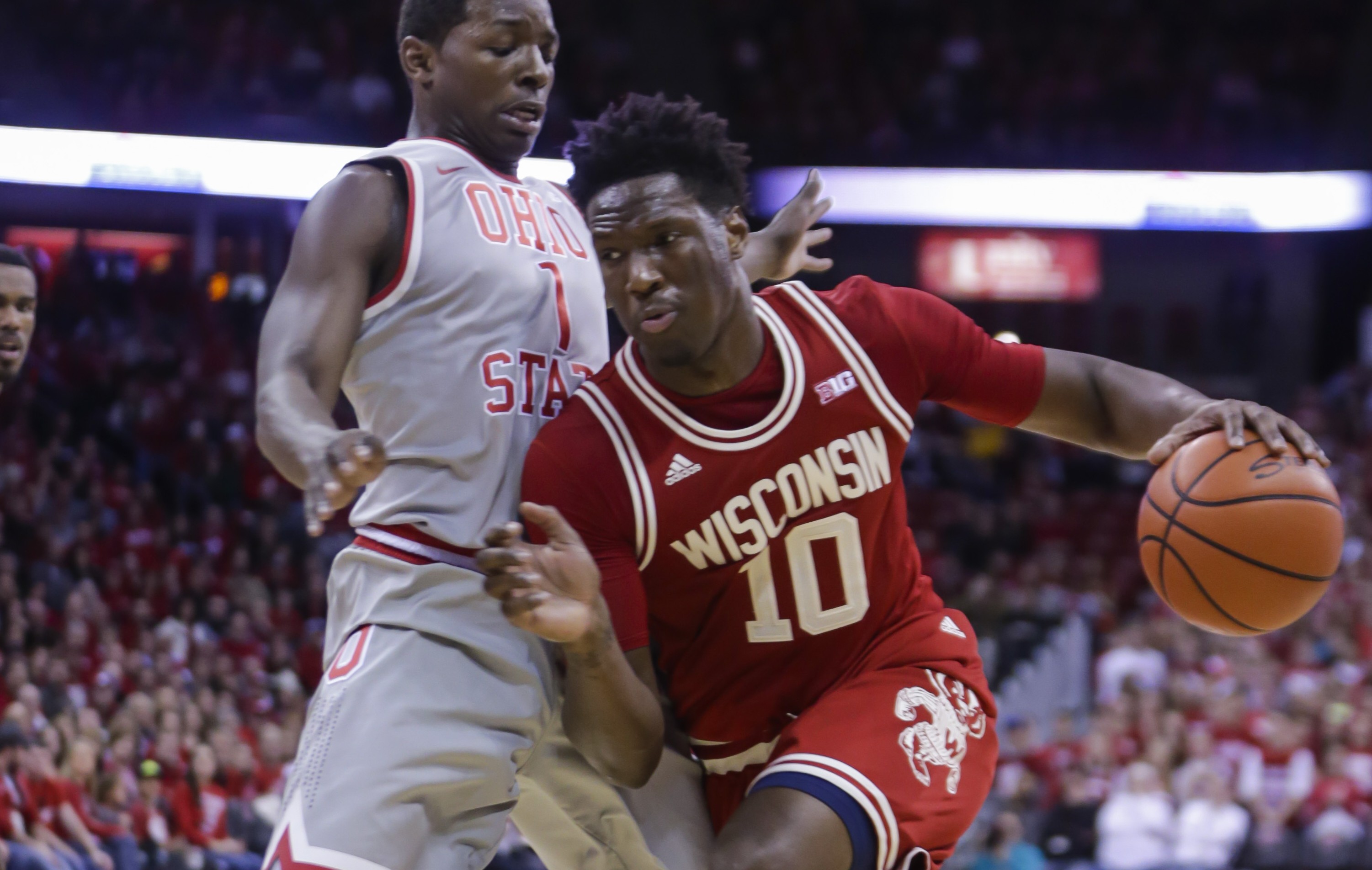 Wisconsin's Nigel Hayes (10) drives on Ohio State's Jae'Sean Tate (1) during the second half of an NCAA college basketball game Thursday, Feb. 4, 2016, in Madison, Wis. Hayes had a team-high 21 points in Wisconsin's 79-68 win. (AP Photo/Andy Manis)