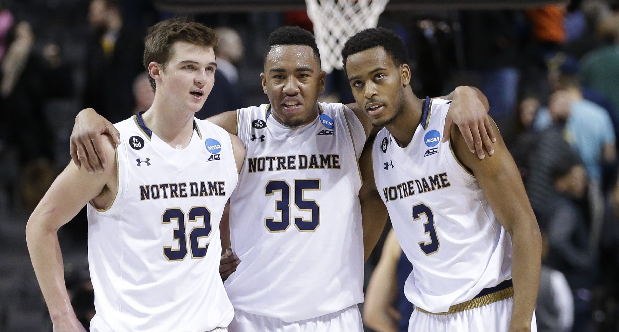Notre Dame's Steve Vasturia (32), Bonzie Colson (35) and V.J. Beachem (3) talk during the second half of a first-round men's college basketball game against Michigan in the NCAA Tournament, Friday, March 18, 2016, in New York. Notre Dame won 70-63. (AP Photo/Frank Franklin II)