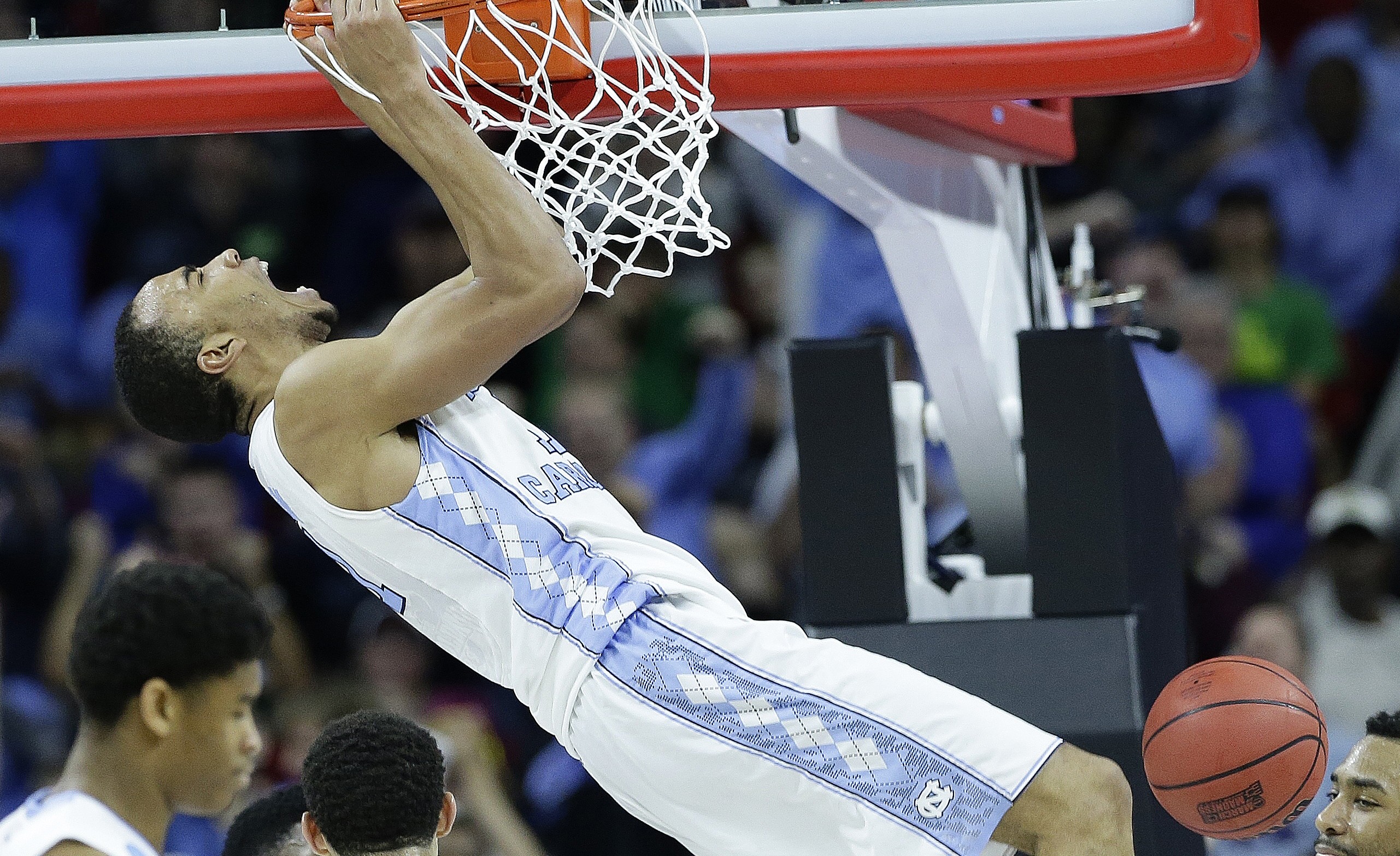 North Carolina forward Brice Johnson (11) reacts after dunking the ball against Providence guard Jalen Lindsey (21) during the second half of a second-round men's college basketball game in the NCAA Tournament, Saturday, March 19, 2016, in Raleigh, N.C. (AP Photo/Gerry Broome)