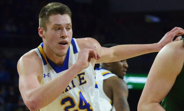 North Dakota State's Dexter Werner (40) looks around South Dakota State's Mike Daum (24) on his way to the net during an NCAA college basketball game for the Summit League men's tournament championship, Tuesday, March 8, 2016, in Sioux Falls, S.D. (Elisha Page/The Argus Leader via AP)