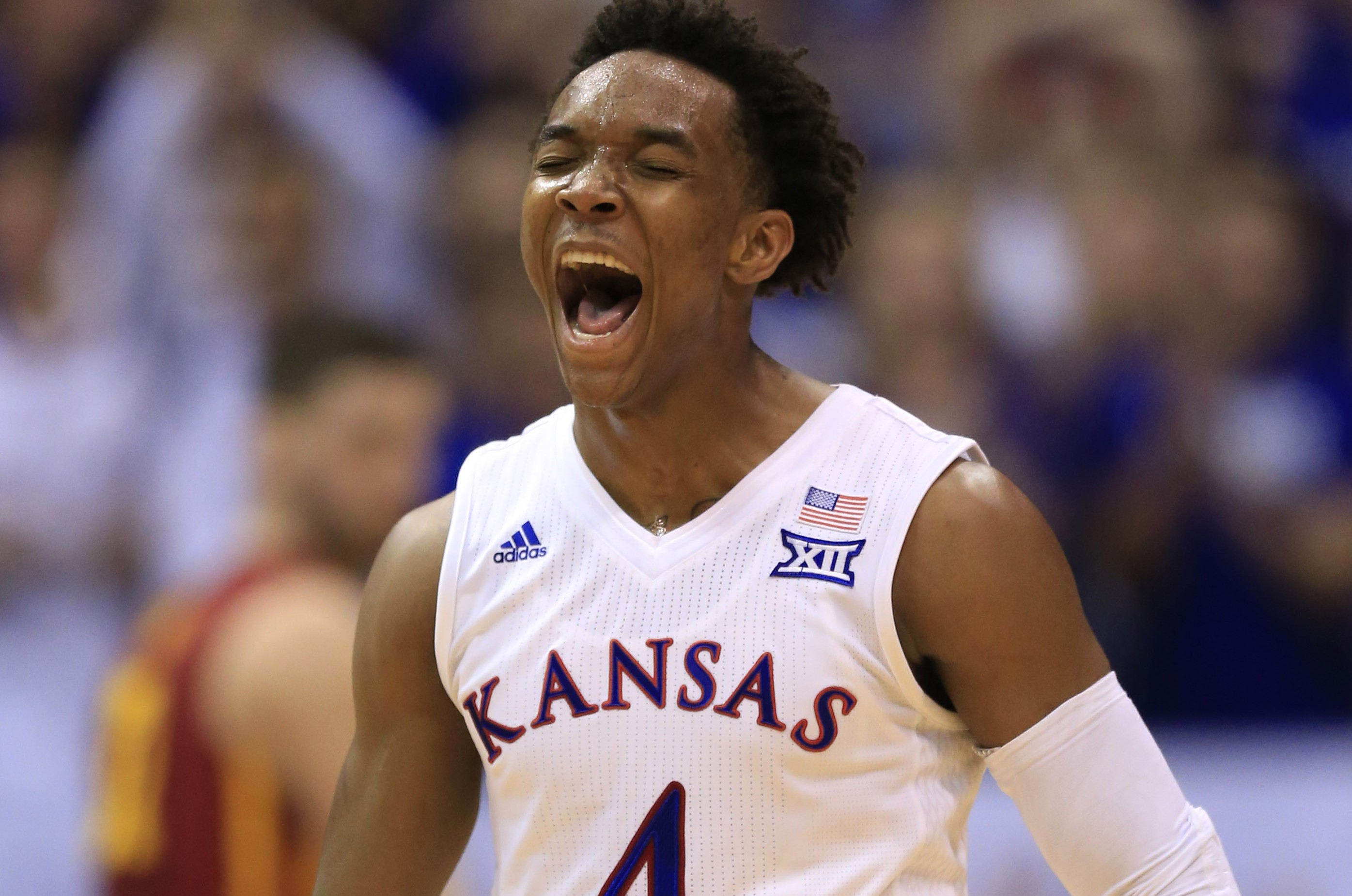 Kansas guard Devonte' Graham (4) celebrates a 3-point basket during the second half of an NCAA college basketball game against Iowa State in Lawrence, Kan., Saturday, March 5, 2016. Kansas defeated Iowa State 85-78. (AP Photo/Orlin Wagner)