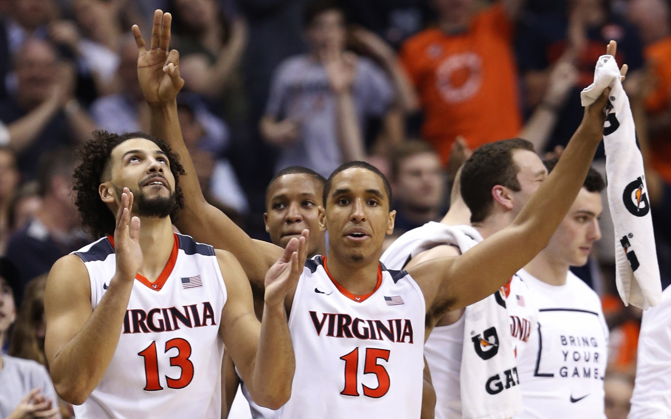 Virginia guard Malcolm Brogdon (15) and forward Anthony Gill (13) cheer their team during the second half against Georgia Tech in an NCAA college basketball game in the Atlantic Coast Conference men's tournament, in Washington on Thursday, March 10, 2016. Virginia defeated Georgia Tech 72-52. (AP Photo/Steve Helber)