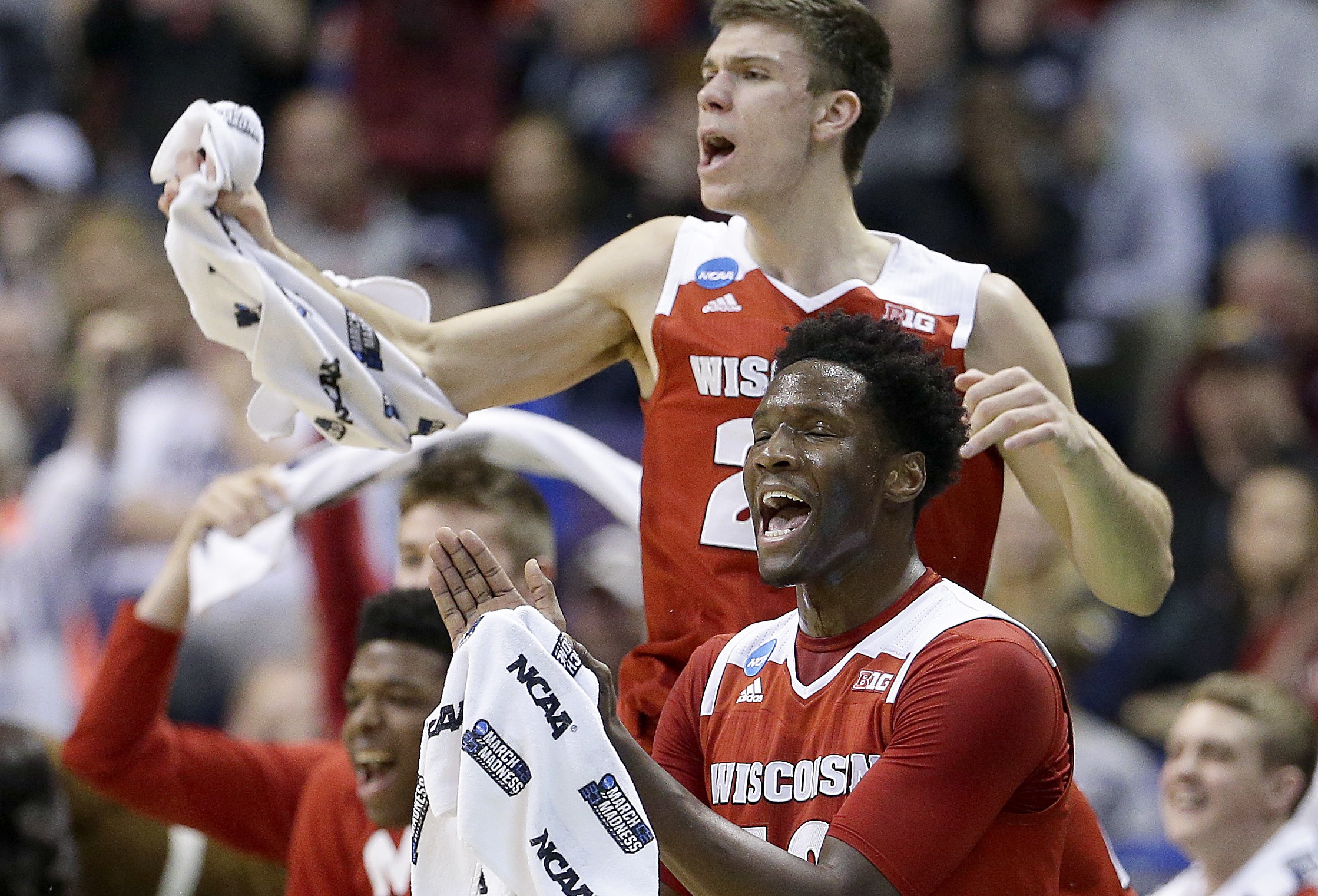 The Wisconsin bench celebrates a basket during the first half of a second-round men's college basketball game against Xavier in the NCAA Tournament, Sunday, March 20, 2016, in St. Louis. (AP Photo/Charlie Riedel)