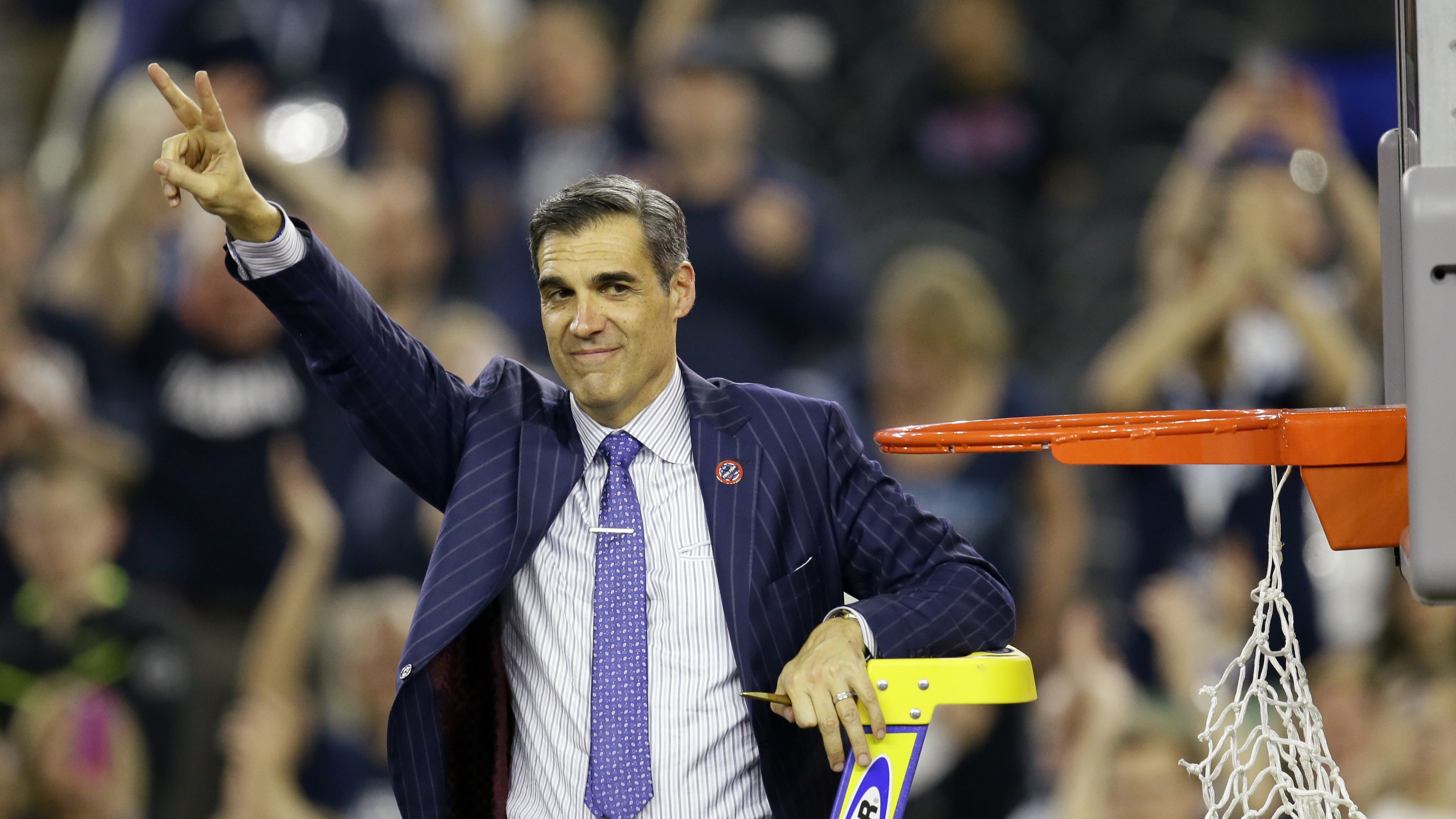 Villanova head coach Jay Wright celebrates as he cuts down the net after the NCAA Final Four tournament college basketball championship game against North Carolina, Monday, April 4, 2016, in Houston. Villanova won 77-74. (AP Photo/Charlie Neibergall)