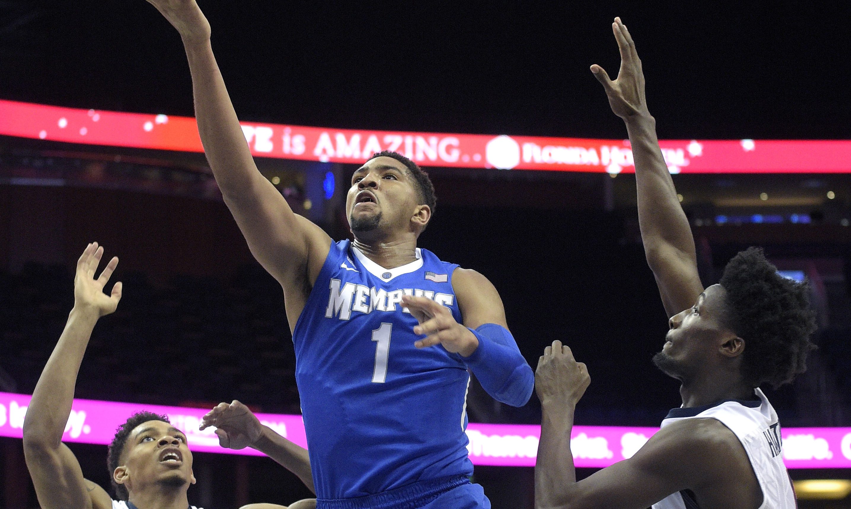 Memphis forward Dedric Lawson (1) goes up for a shot between Connecticut forward Shonn Miller (32) and guard Daniel Hamilton, right, during the first half of an NCAA college basketball game in the finals of the American Athletic Conference men's tournament in Orlando, Fla., Sunday, March 13, 2016. (AP Photo/Phelan M. Ebenhack)