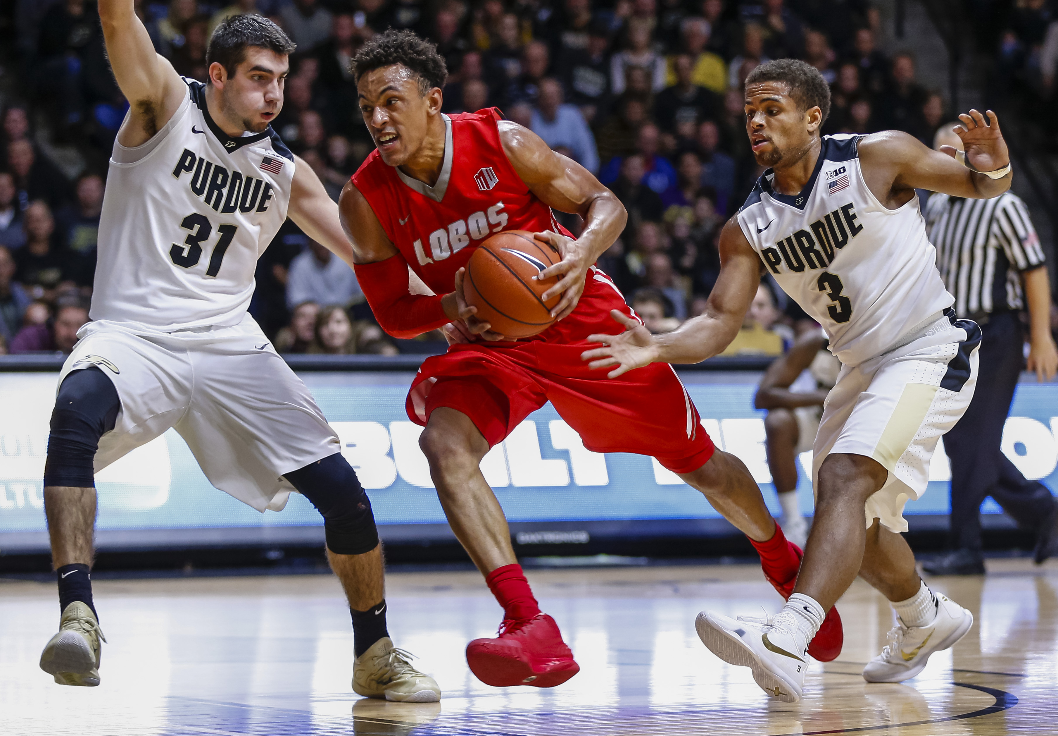 WEST LAFAYETTE, IN - DECEMBER 5: Elijah Brown #4 of the New Mexico Lobos dribbles to the hoop as Dakota Mathias #31 and P.J. Thompson #3 of the Purdue Boilermakers defend at Mackey Arena on December 5, 2015 in West Lafayette, Indiana. Purdue defeated New Mexico 70-58. (Photo by Michael Hickey/Getty Images)