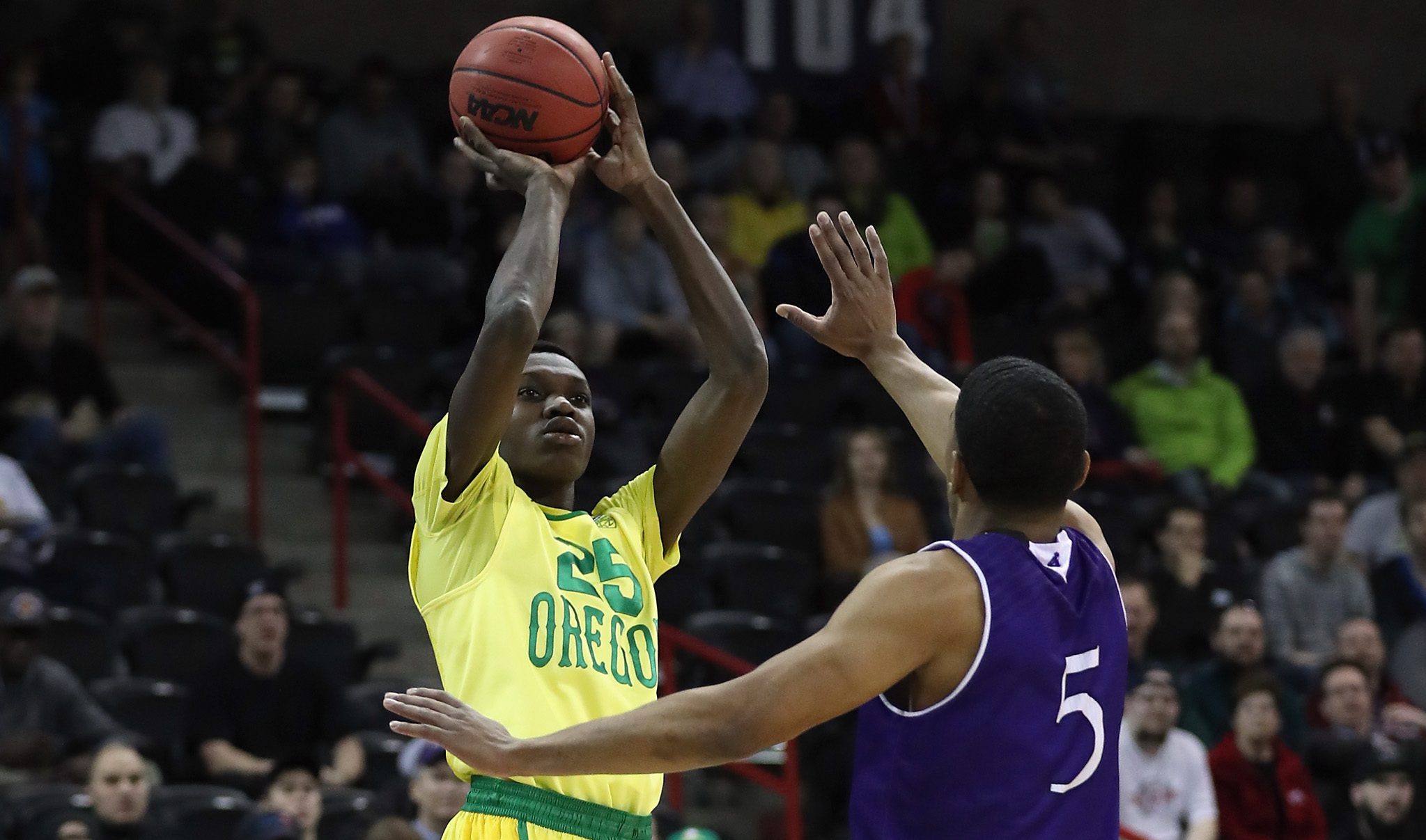 SPOKANE, WA - MARCH 18: Chris Boucher #25 of the Oregon Ducks shoots against Cullen Hamilton #5 of the Holy Cross Crusaders in the first half during the first round of the 2016 NCAA Men's Basketball Tournament at Spokane Veterans Memorial Arena on March 18, 2016 in Spokane, Washington. (Photo by Ezra Shaw/Getty Images)