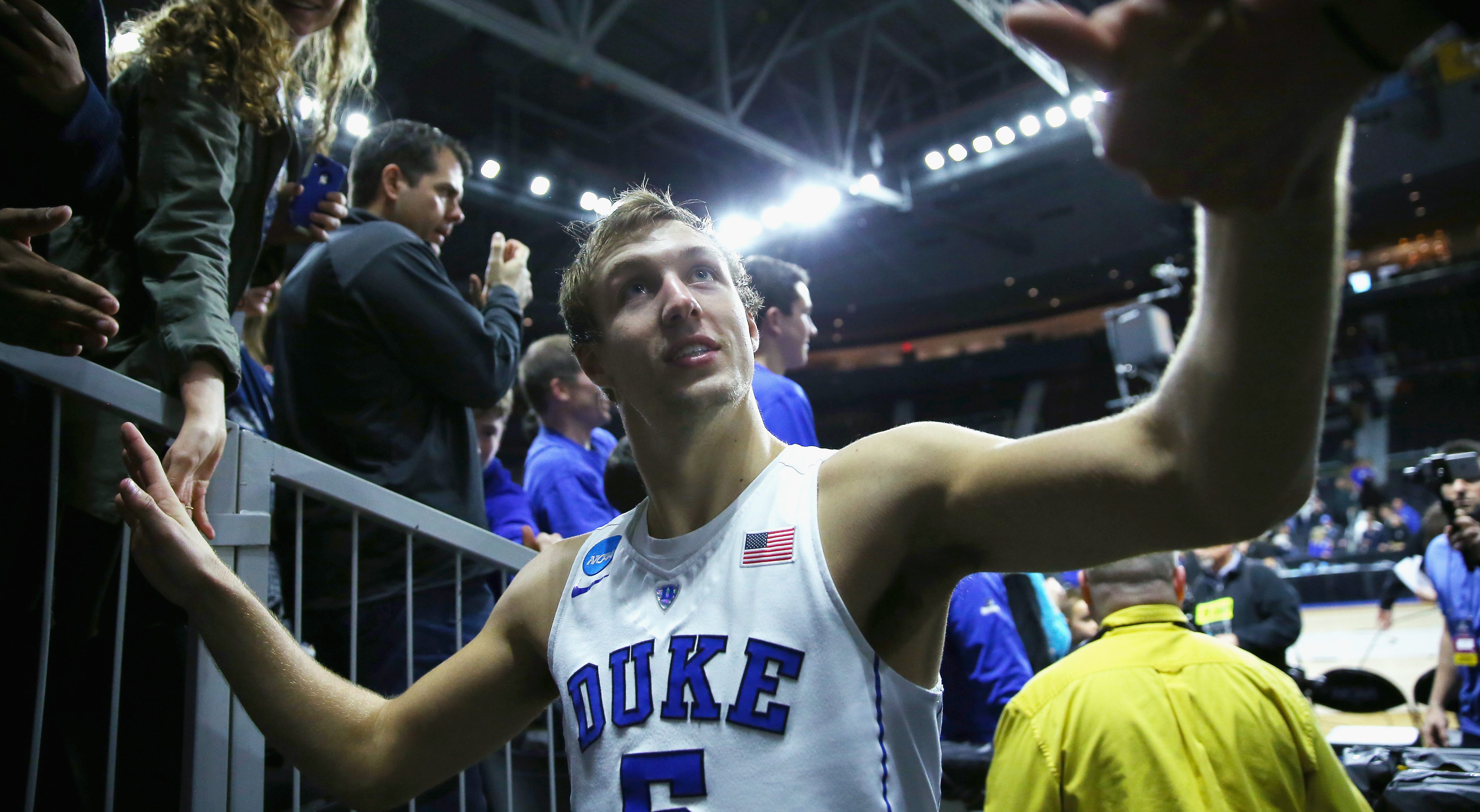 PROVIDENCE, RI - MARCH 19: Luke Kennard #5 of the Duke Blue Devils greets fans after defeating the Yale Bulldogs 71-64 during the second round of the 2016 NCAA Men's Basketball Tournament at Dunkin' Donuts Center on March 19, 2016 in Providence, Rhode Island. (Photo by Jim Rogash/Getty Images)