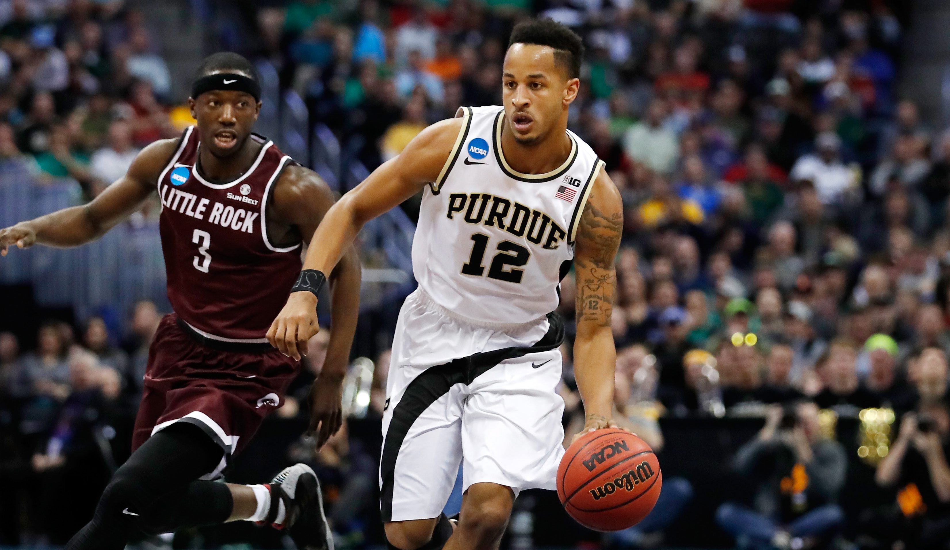 DENVER, CO - MARCH 17: Vince Edwards #12 of the Purdue Boilermakers drives the ball past Josh Hagins #3 of the Arkansas Little Rock Trojans during the first round of the 2016 NCAA Men's Basketball Tournament at the Pepsi Center on March 17, 2016 in Denver, Colorado. (Photo by Justin Edmonds/Getty Images)