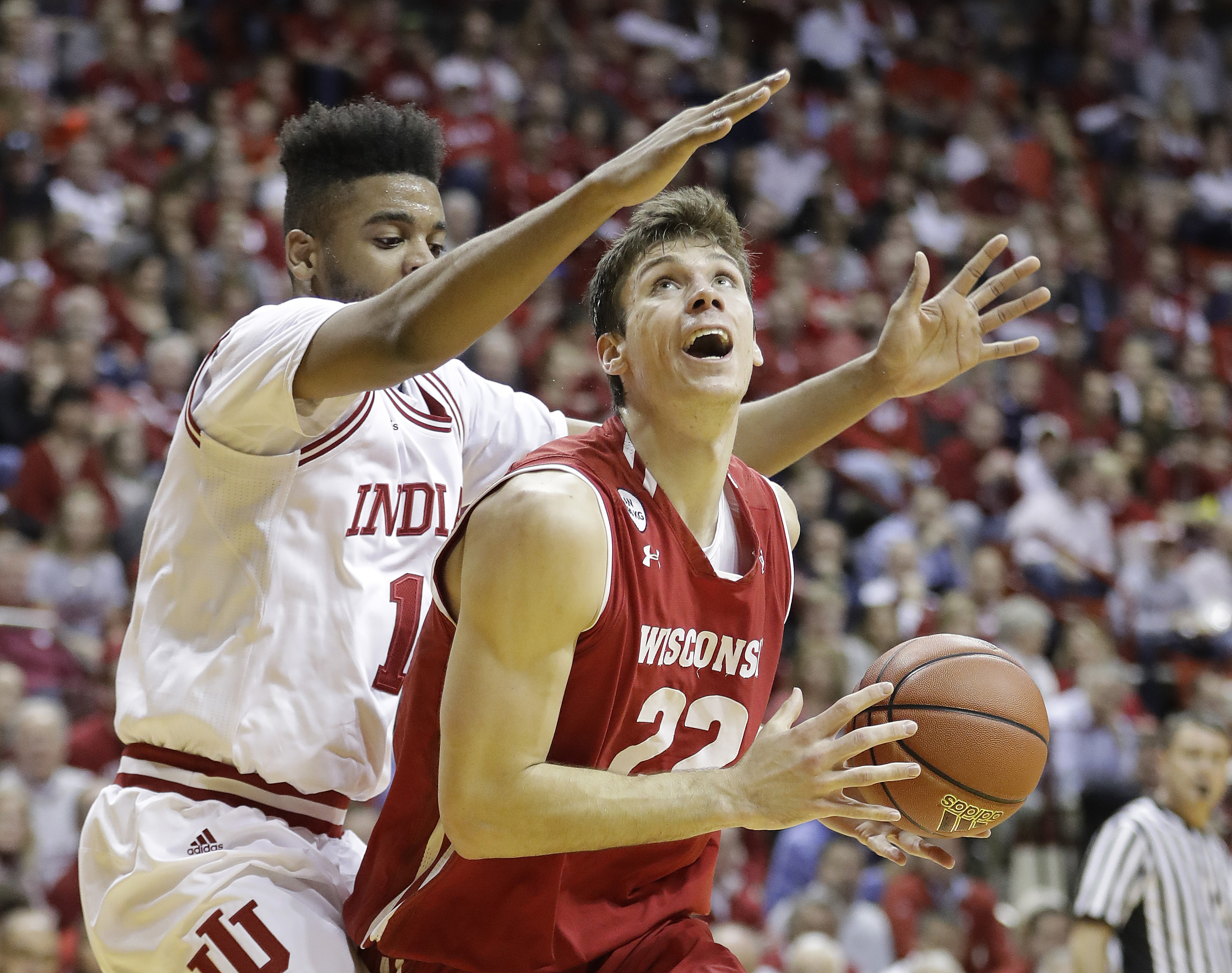 Wisconsin's Ethan Happ is defended by Indiana's Juwan Morgan during the first half of an NCAA college basketball game Tuesday, Jan. 3, 2017, in Bloomington Ind. (AP Photo/Darron Cummings)