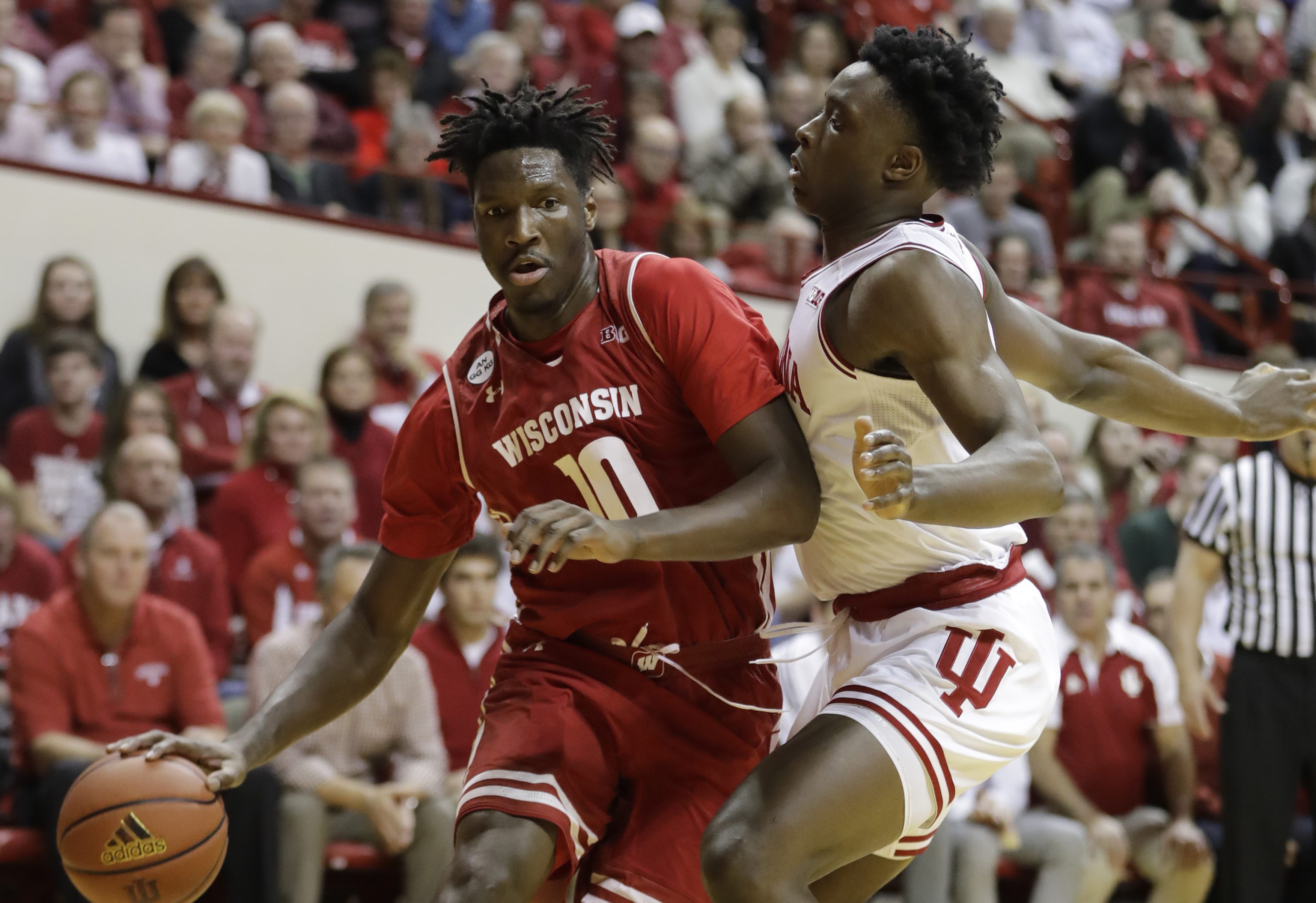 Wisconsin's Nigel Hayes is defended by Indiana's OG Anunoby during the first half of an NCAA college basketball game Tuesday, Jan. 3, 2017, in Bloomington Ind. (AP Photo/Darron Cummings)