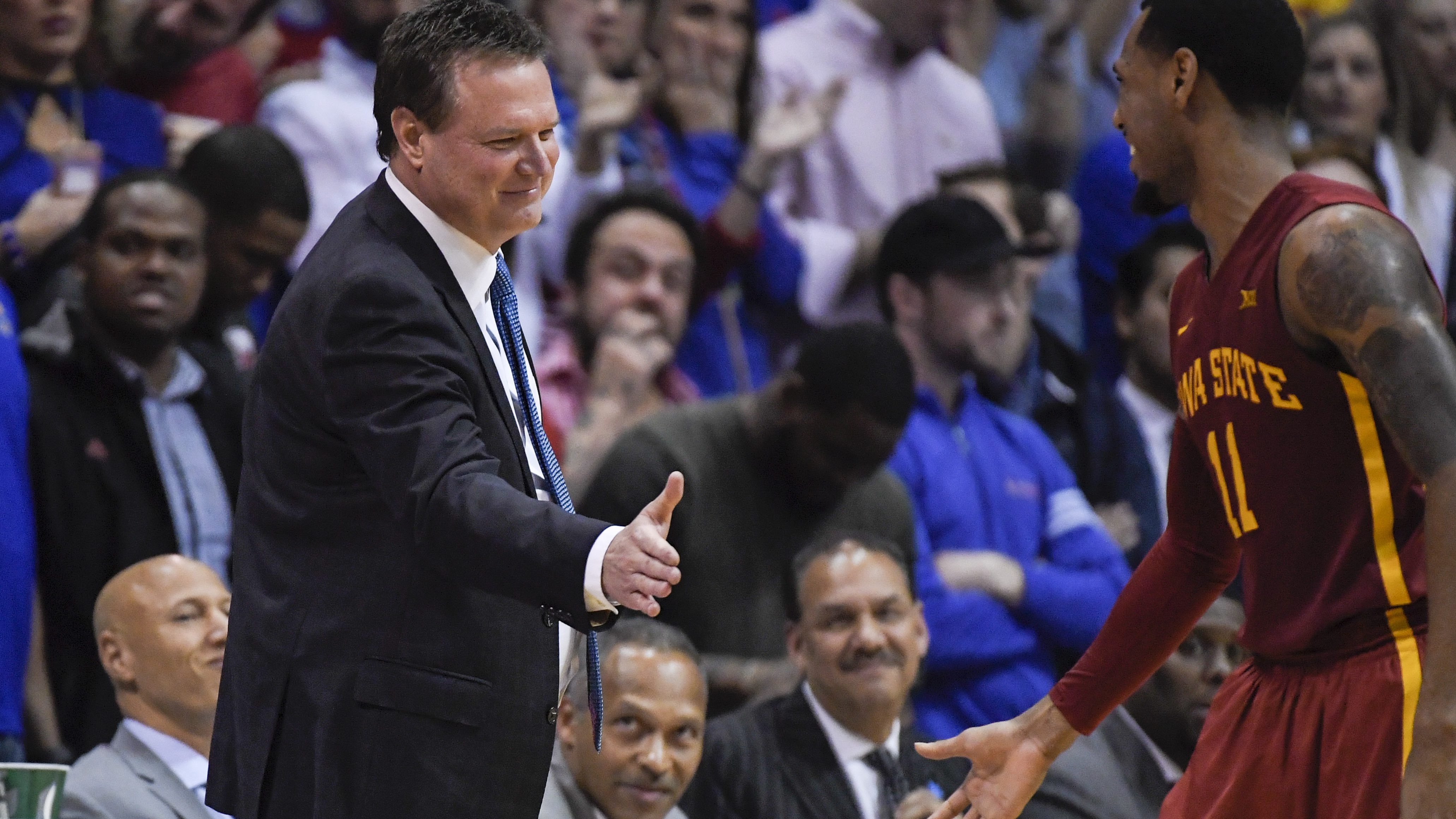 LAWRENCE, KS - FEBRUARY 04: Head coach Bill Self of the Kansas Jayhawks greets Monte Morris #11 of the Iowa State Cyclones during a break in their game on February 4, 2017 at Allen Field House in Lawrence, Kansas. (Photo by Reed Hoffmann/Getty Images)