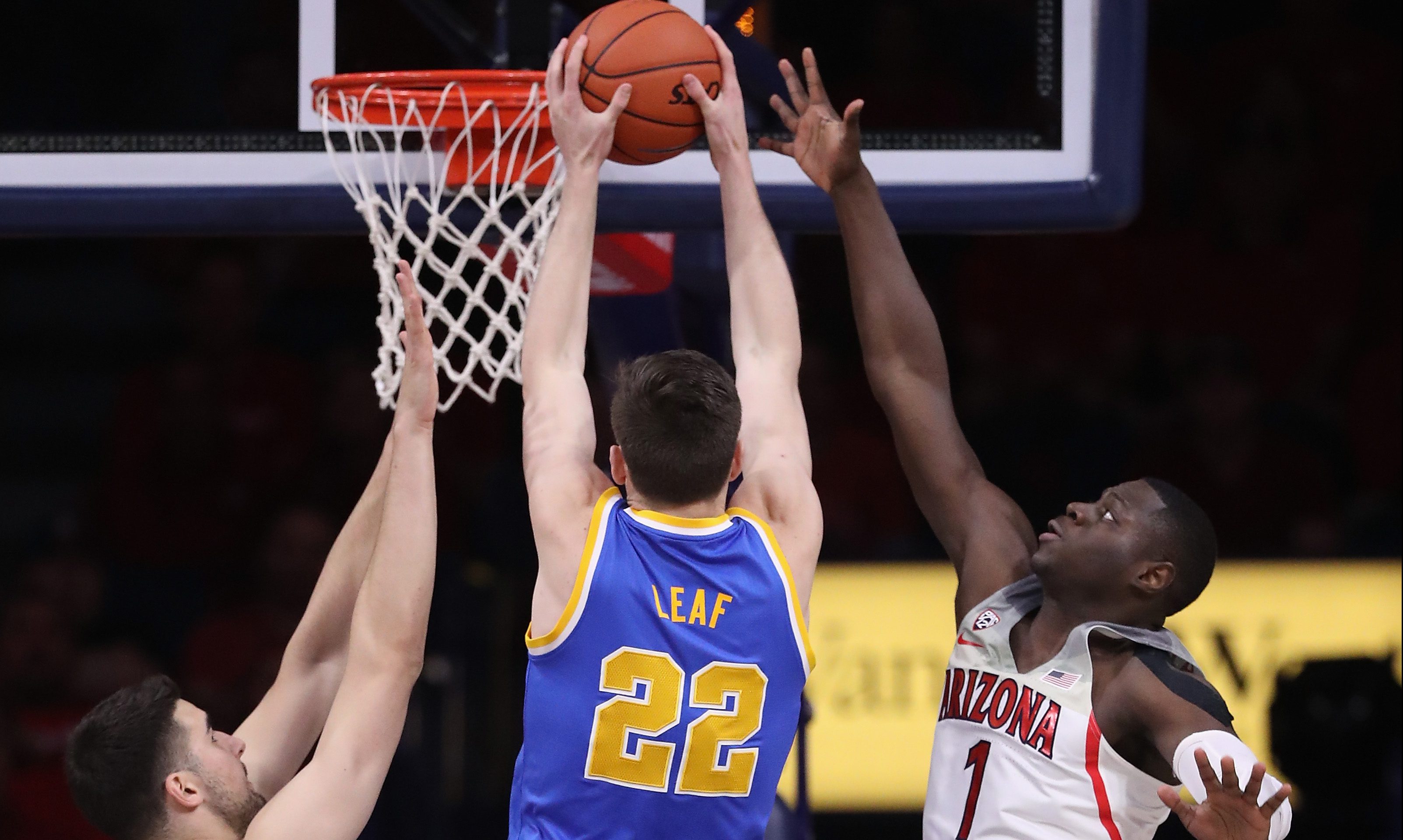 TUCSON, AZ - FEBRUARY 25: TJ Leaf #22 of the UCLA Bruins attempts a shot between Dusan Ristic #14 and Rawle Alkins #1 of the Arizona Wildcats during the first half of the college basketball game at McKale Center on February 25, 2017 in Tucson, Arizona. (Photo by Christian Petersen/Getty Images)