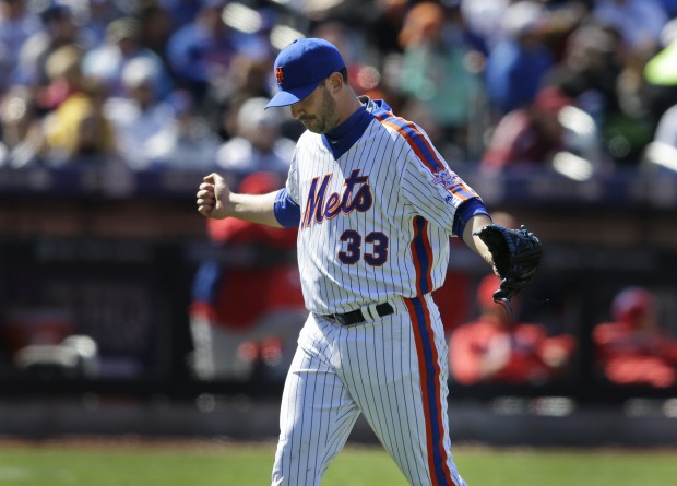 New York Mets starting pitcher Matt Harvey punches his fist into his glove during the sixth inning of the baseball game against the Philadelphia Phillies at Citi Field, Sunday, April 10, 2016, in New York. (AP Photo/Seth Wenig)