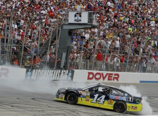 DOVER, DE - JUNE 02: Tony Stewart, driver of the #14 Code 3 Associates/Mobil 1 Chevrolet, celebrates with a burnout after winning the NASCAR Sprint Cup Series FedEx 400 benefiting Autism Speaks at Dover International Speedway on June 2, 2013 in Dover, Delaware. (Photo by Jerry Markland/Getty Images)