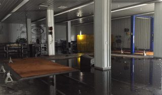 Water flooded part of the ThorSport Racing shop after firefighters battled a blaze at the shop Monday. (Photo by ThorSport Racing)