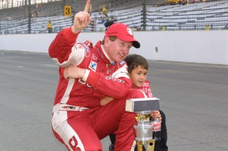 Chase Elliott and his father celebrate after the 2002 Brickyard 400 (photo by Indianapolis Motor Speedway).