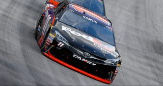 BRISTOL, TN - AUGUST 21: Denny Hamlin, driver of the #11 FedEx Express Toyota, leads a pack of cars during the NASCAR Sprint Cup Series Bass Pro Shops NRA Night Race at Bristol Motor Speedway on August 21, 2016 in Bristol, Tennessee. The race was delayed due to inclement weather on Saturday, August 20. (Photo by Brian Lawdermilk/Getty Images)