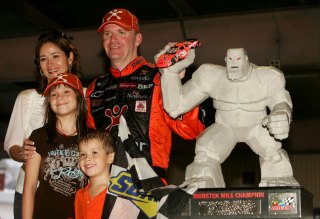 DOVER, DE - SEPTEMBER 24: Jeff Burton, driver of the #31 Cingular Wireless Chevrolet, stands with the winners trophy and his wife Kim, daughter Paige, and son Harrison, following the NASCAR Nextel Cup Series Dover 400 on September 24, 2006 at Dover International Speedway in Dover, Delaware. (Photo by Jonathan Ferrey/Getty Images for NASCAR)