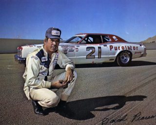 Driver David Pearson poses next to his famous #21 Wood Brothers Mercury at Riverside Raceway circa 1972