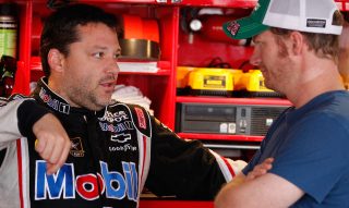 DOVER, DE - JUNE 01: Tony Stewart, driver of the #14 Mobil 1/Office Depot Chevrolet, talks to Dale Earnhardt Jr., driver of the #88 AMP Energy/National Guard Chevrolet, in the garage area during practice for the NASCAR Sprint Cup Series FedEx 400 benefiting Autism Speaks at Dover International Speedway on June 1, 2012 in Dover, Delaware. (Photo by Rob Carr/Getty Images for NASCAR)