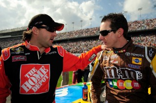 DAYTONA BEACH, FL - FEBRUARY 17: Tony Stewart, driver of the #20 The Home Depot Toyota, speaks with teammate Kyle Busch, driver of the #18 M&M's Toyota, prior to the NASCAR Sprint Cup Series Daytona 500 at Daytona International Speedway on February 17, 2008 in Daytona Beach, Florida. (Photo by Rusty Jarrett/Getty Images for NASCAR)
