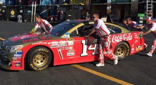 Tony Stewart's throwback car pushed by his crew in their throwback uniforms at Darlington Raceway. (Photo: Dustin Long)